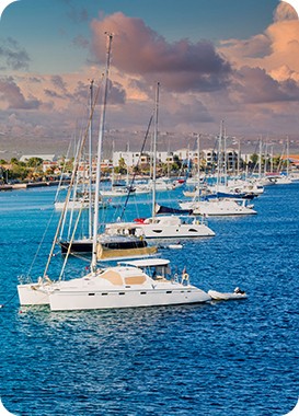 Boats on the waters of Bonaire. See the beautiful Bonaire destinations that Maduro Travel has to offer and discover Bonaire.